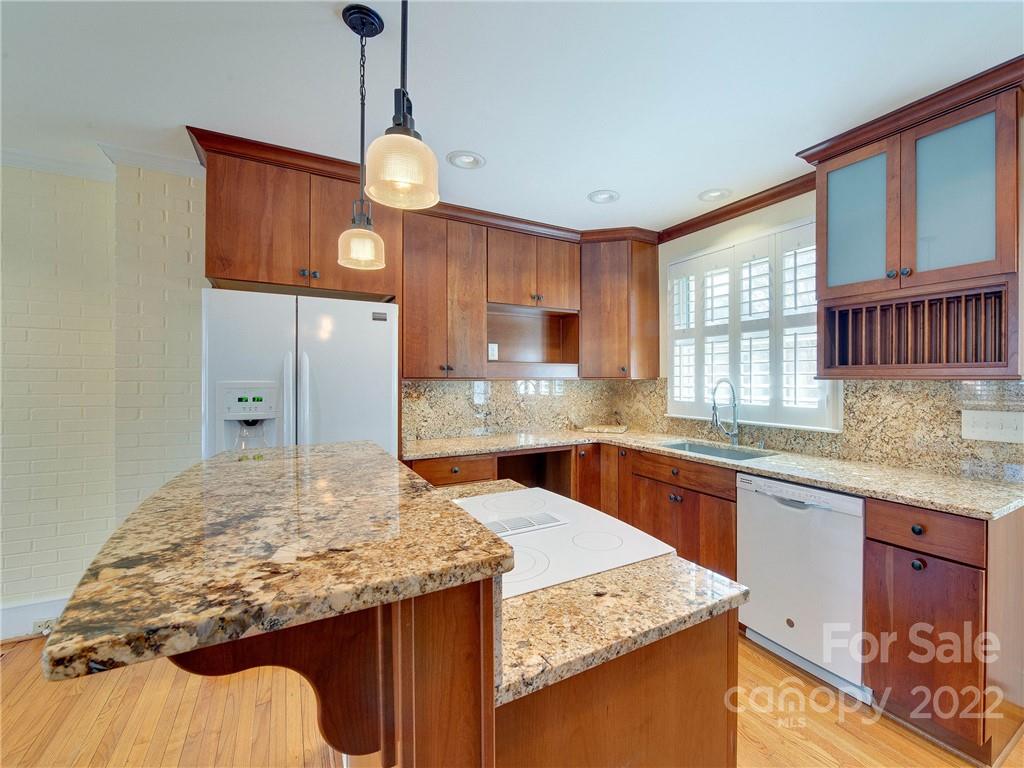 1007 Andover Road, Unit A3 Charlotte, NC 28211 - Photo 12 of 38 a kitchen with stainless steel appliances granite countertop stove a sink dishwasher and wooden cabinets with wooden floor