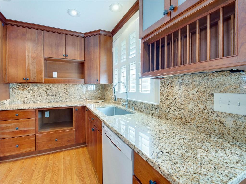 1007 Andover Road, Unit A3 Charlotte, NC 28211 - Photo 16 of 38 a kitchen with granite countertop a sink stove and cabinets