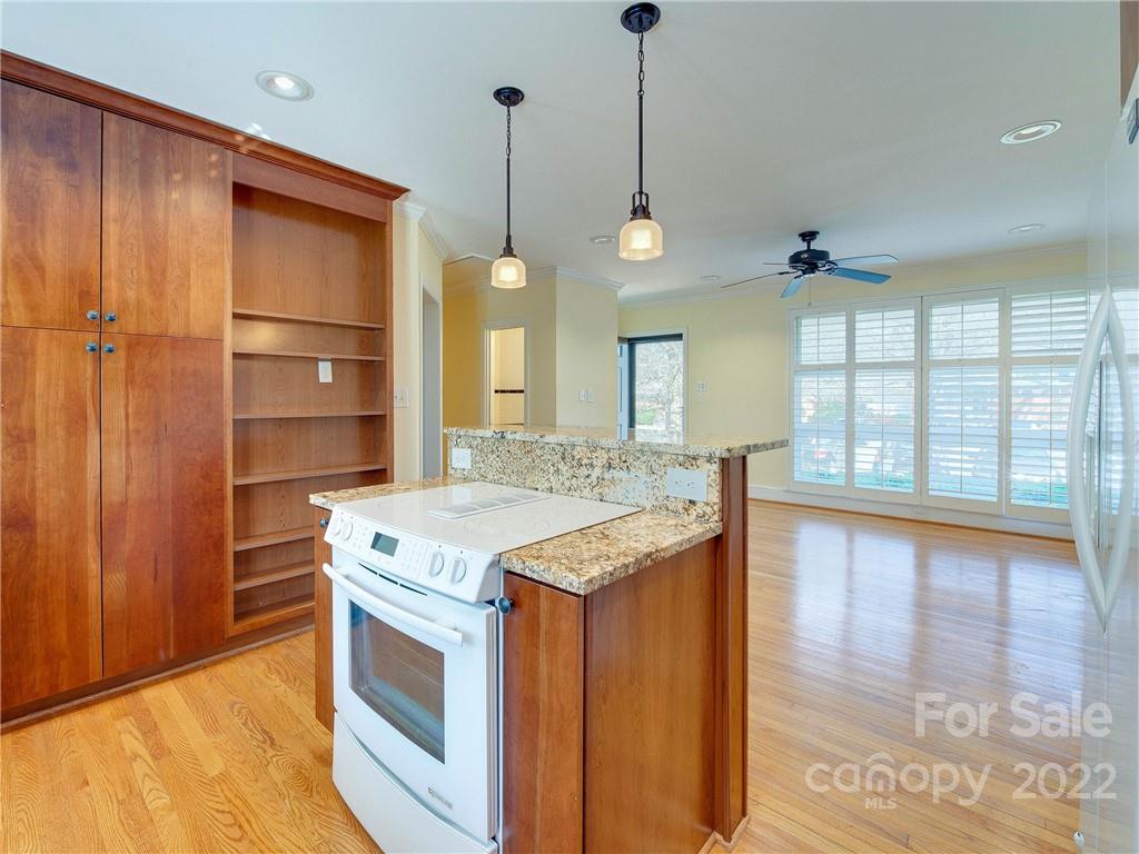 1007 Andover Road, Unit A3 Charlotte, NC 28211 - Photo 18 of 38 a kitchen with a stove and a wooden floors