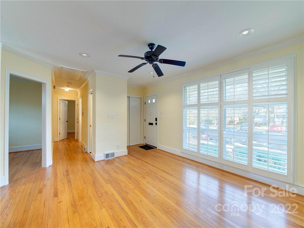 1007 Andover Road, Unit A3 Charlotte, NC 28211 - Photo 2 of 38 a view of empty room with wooden floor and fan