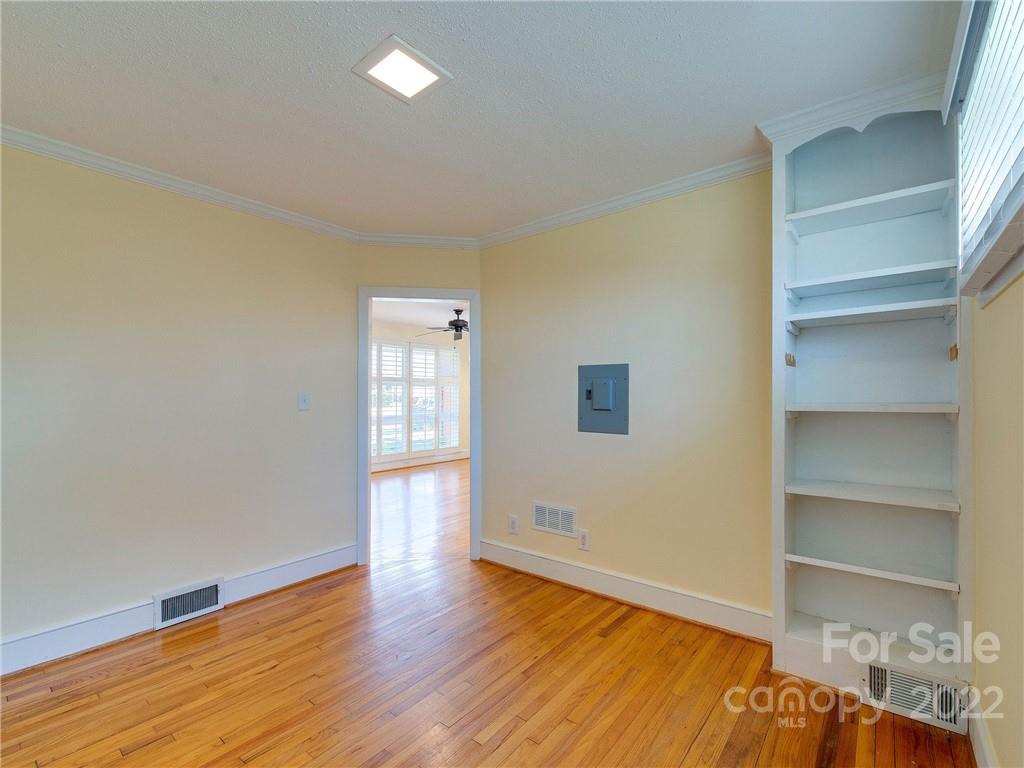 1007 Andover Road, Unit A3 Charlotte, NC 28211 - Photo 22 of 38 a view of an empty room with wooden floor and a window