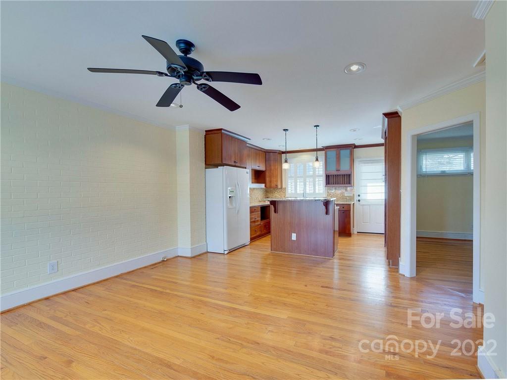 1007 Andover Road, Unit A3 Charlotte, NC 28211 - Photo 3 of 38 a view of empty room with wooden floor and ceiling fan
