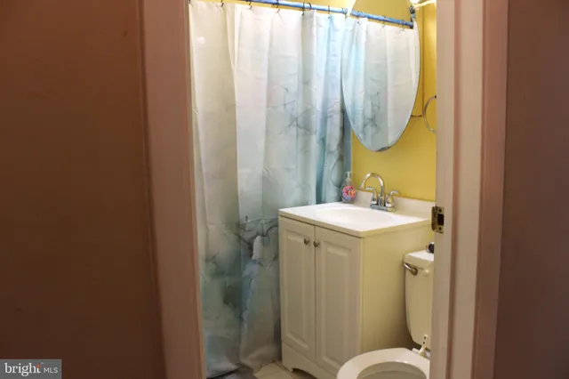a bathroom with a sink mirror and toilet