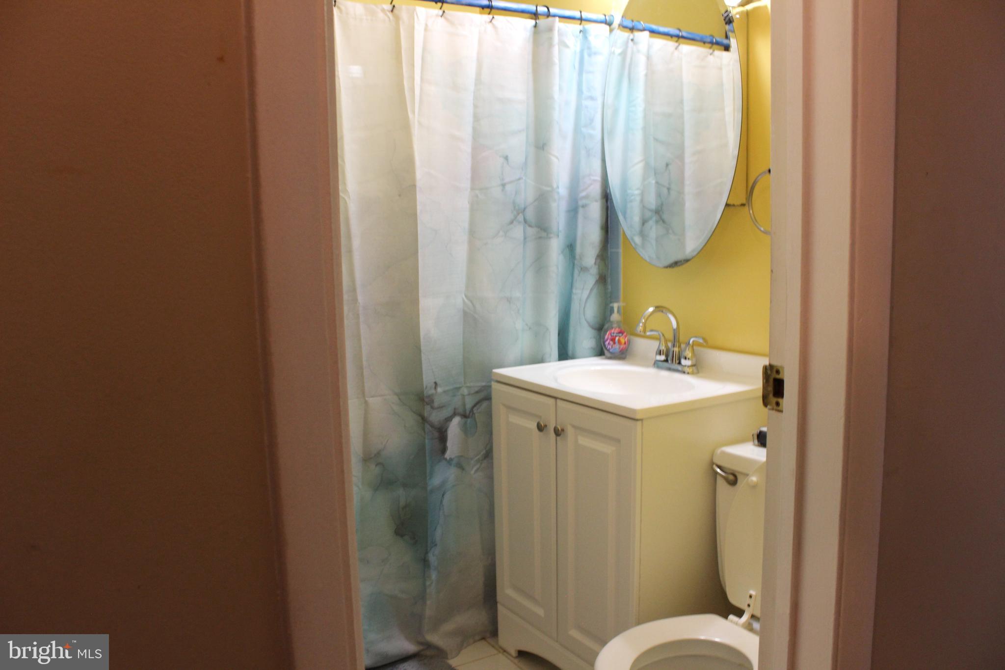 418 Florida Avenue Herndon, VA 20170 - Photo 11 of 14 a bathroom with a sink mirror and toilet