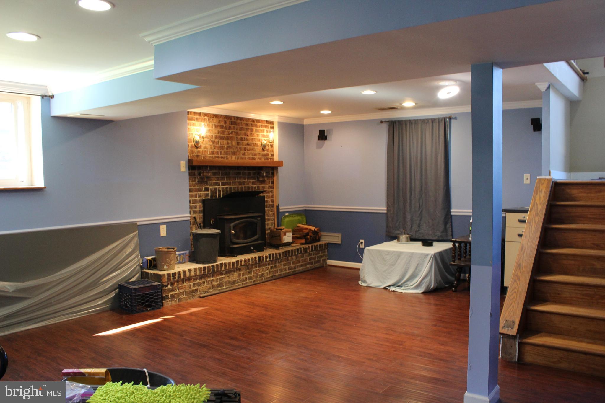 418 Florida Avenue Herndon, VA 20170 - Photo 12 of 14 a living room with furniture a fireplace and a flat screen tv