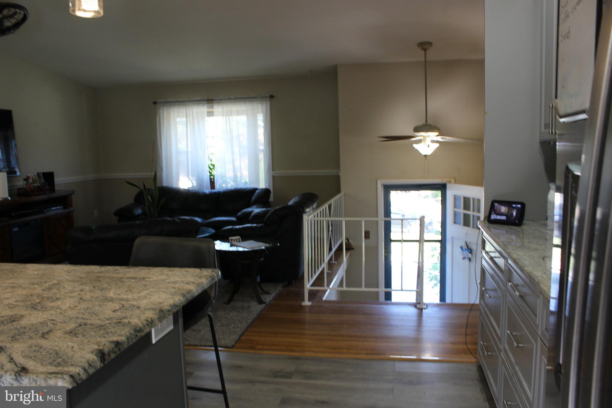 418 Florida Avenue Herndon, VA 20170 - Photo 6 of 14 a living room with furniture wooden floor and a chandelier