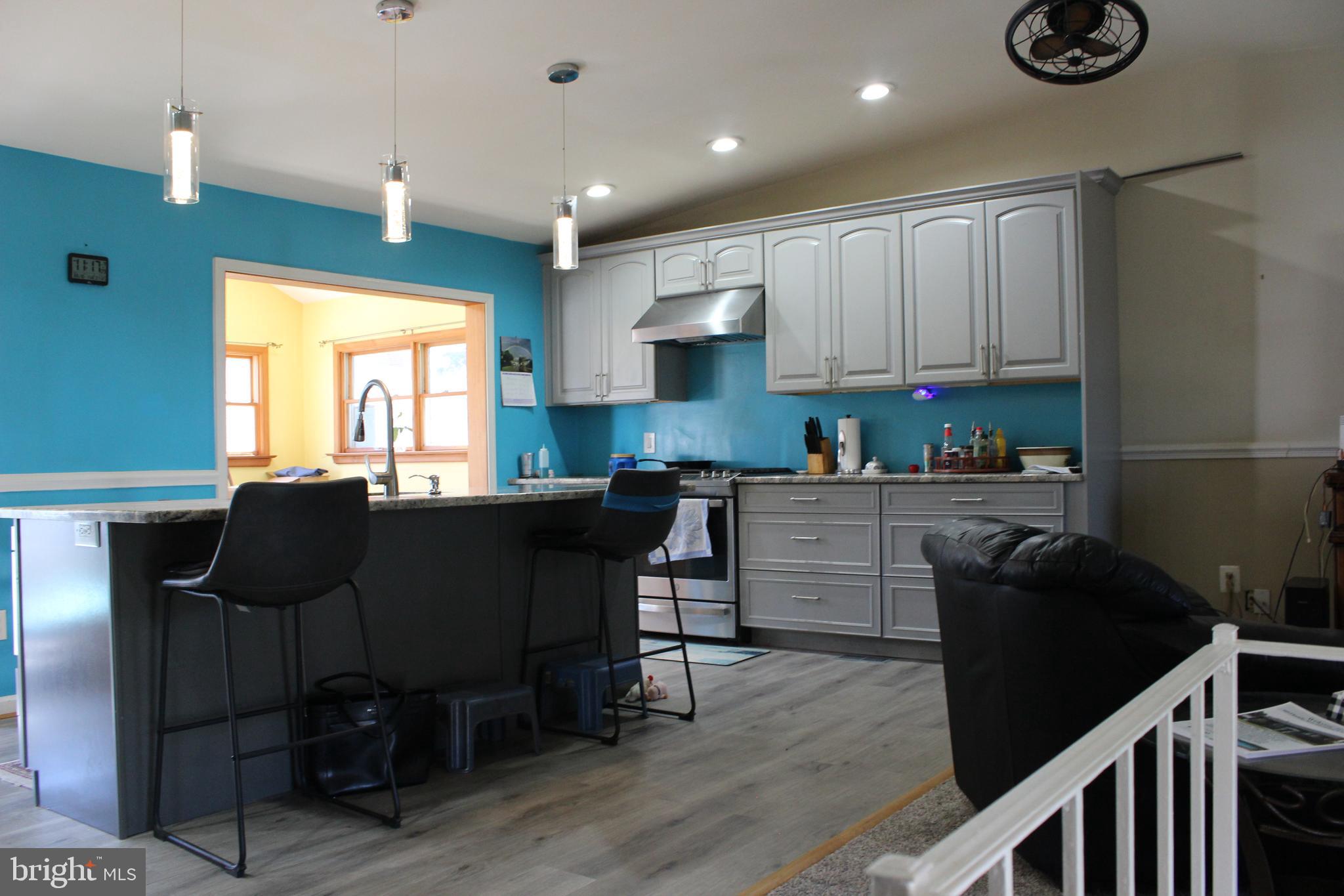 418 Florida Avenue Herndon, VA 20170 - Photo 7 of 14 a kitchen with a table chairs refrigerator and cabinets