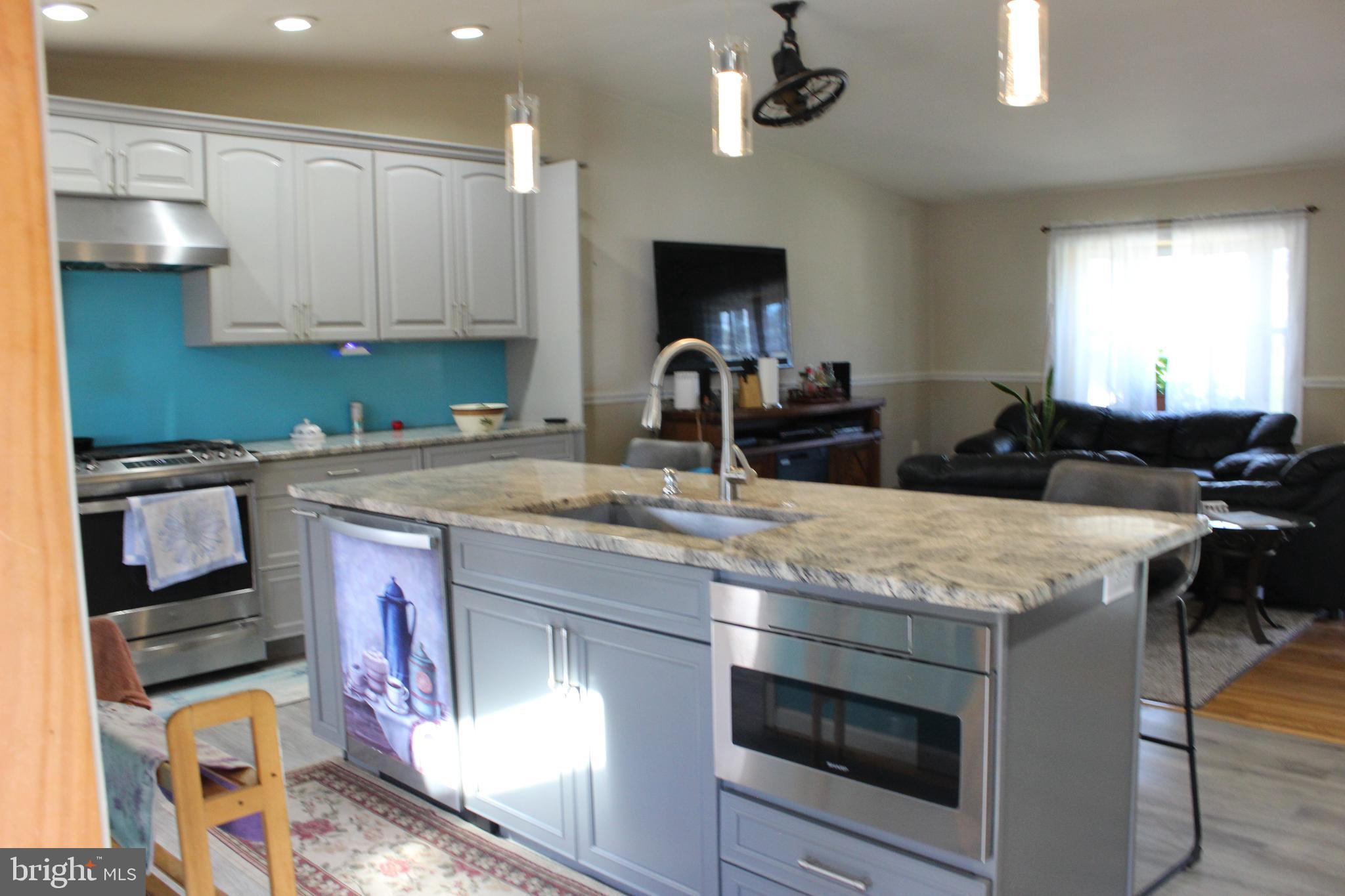 418 Florida Avenue Herndon, VA 20170 - Photo 8 of 14 a kitchen with stainless steel appliances granite countertop a stove a sink and a microwave