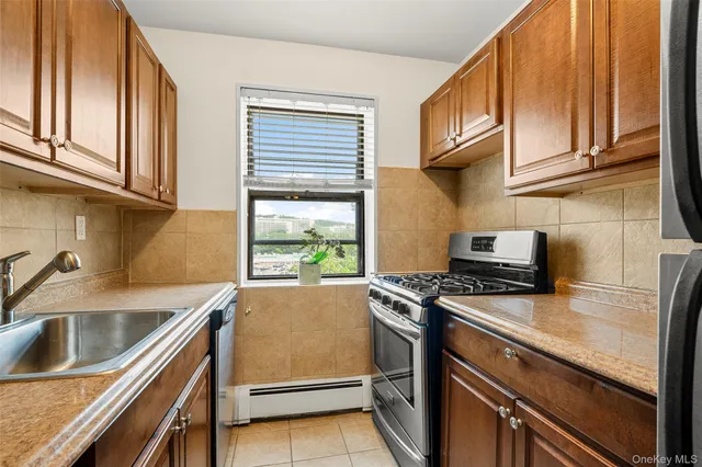 a kitchen with a sink stove top oven and cabinets