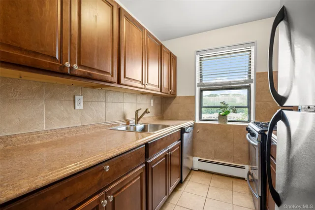 a kitchen with a sink cabinets and window