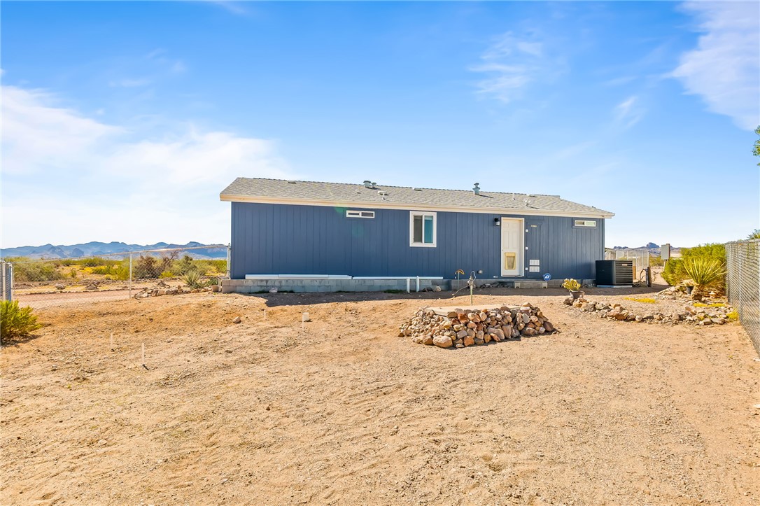 3534 Eloy Road Golden Valley, AZ 86413 - Photo 44 of 58 Rear view of property with a mountain view and a shingled roof