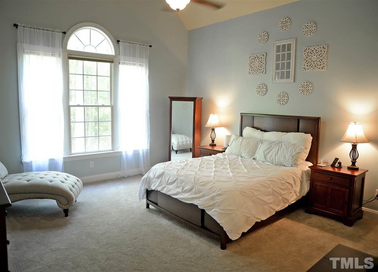5800 Stone Canyon Court Raleigh, NC 27613 - Photo 10 of 30 Tucked away on the first floor is the master bedroom with soaring cathedral ceiling! Wake up to a gorgeous and private view every day! This master bedroom is large enough for your over sized bedroom set and a sitting area or nursery space.
