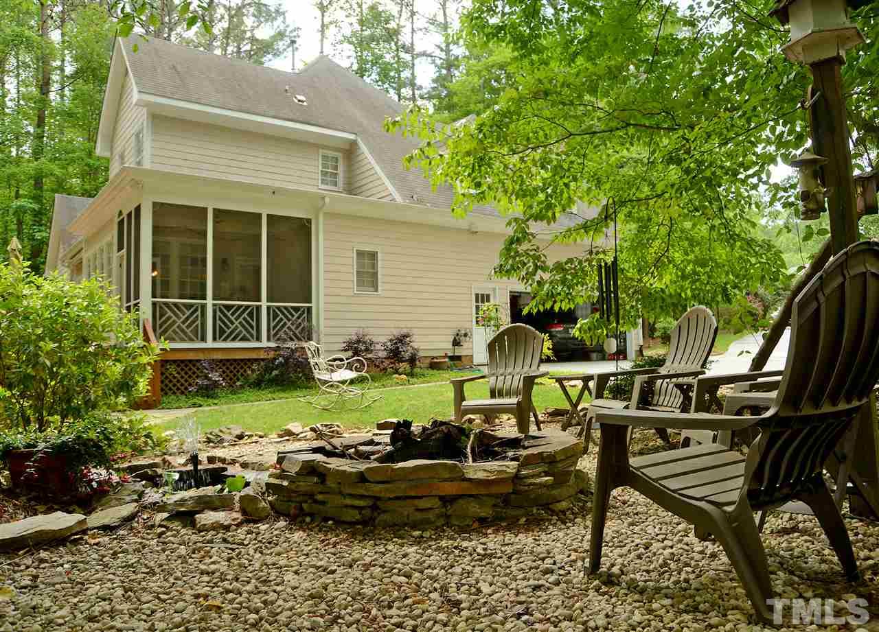 5800 Stone Canyon Court Raleigh, NC 27613 - Photo 17 of 30 Side view from the fantastic outdoor fire pit area! Notice the side entry door to the garage and the proximity of the screened porch and deck. GREAT ENTERTAINING! So many features surround this gorgeous property.