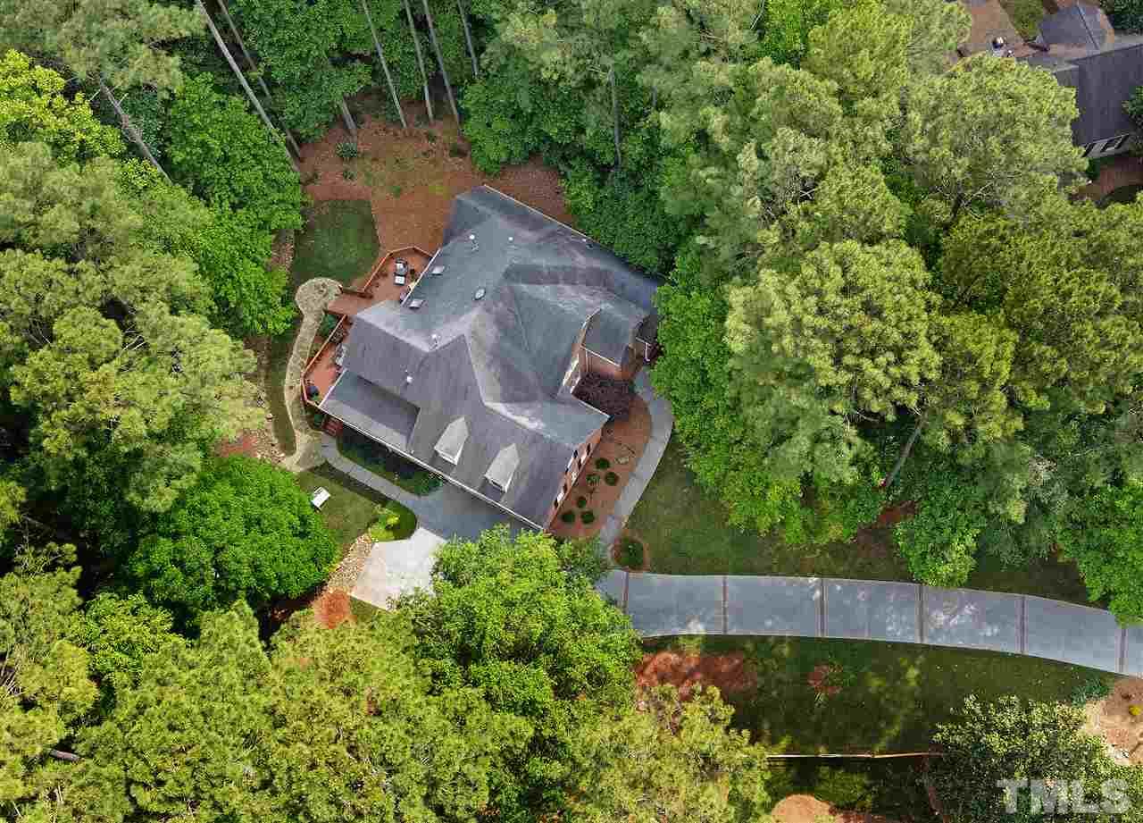 5800 Stone Canyon Court Raleigh, NC 27613 - Photo 21 of 30 Thanks to our drone photography, you can take in the lushness of the landscaping and natural areas. Much of the 2+ acres is low maintenance! Truly a gem tucked away offering so much privacy!