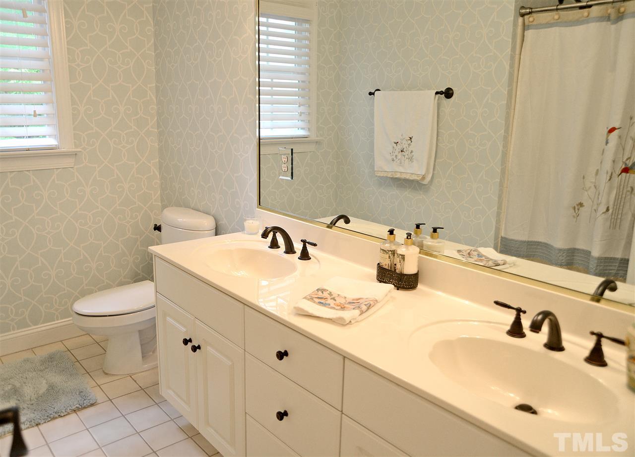5800 Stone Canyon Court Raleigh, NC 27613 - Photo 26 of 30 Upstairs bathroom with dual vanities and updated fixtures. Tile surround tub and ceramic tile flooring.