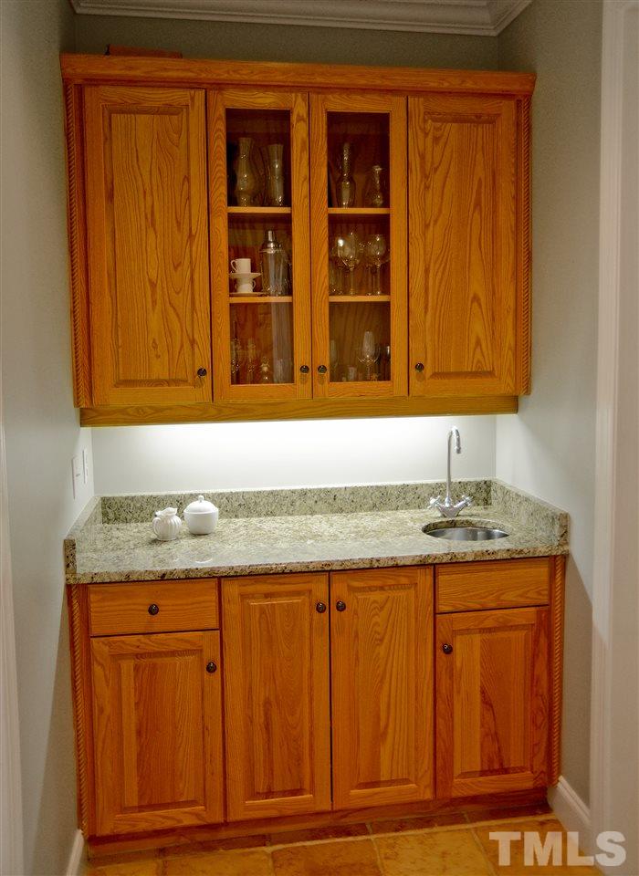 5800 Stone Canyon Court Raleigh, NC 27613 - Photo 27 of 30 Butler Pantry adds style and functionality with additional sink and storage. Located between formal dining room and kitchen.