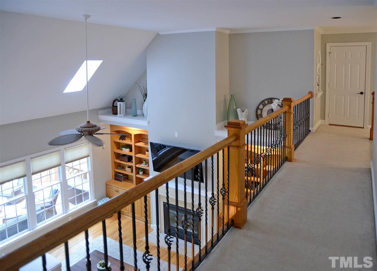 5800 Stone Canyon Court Raleigh, NC 27613 - Photo 28 of 30 Stylish catwalk which extends from the walk in attic to the upstairs wing of the home. The walk in attic is two story, don't miss the stairs in the attic that leads to additional storage space.