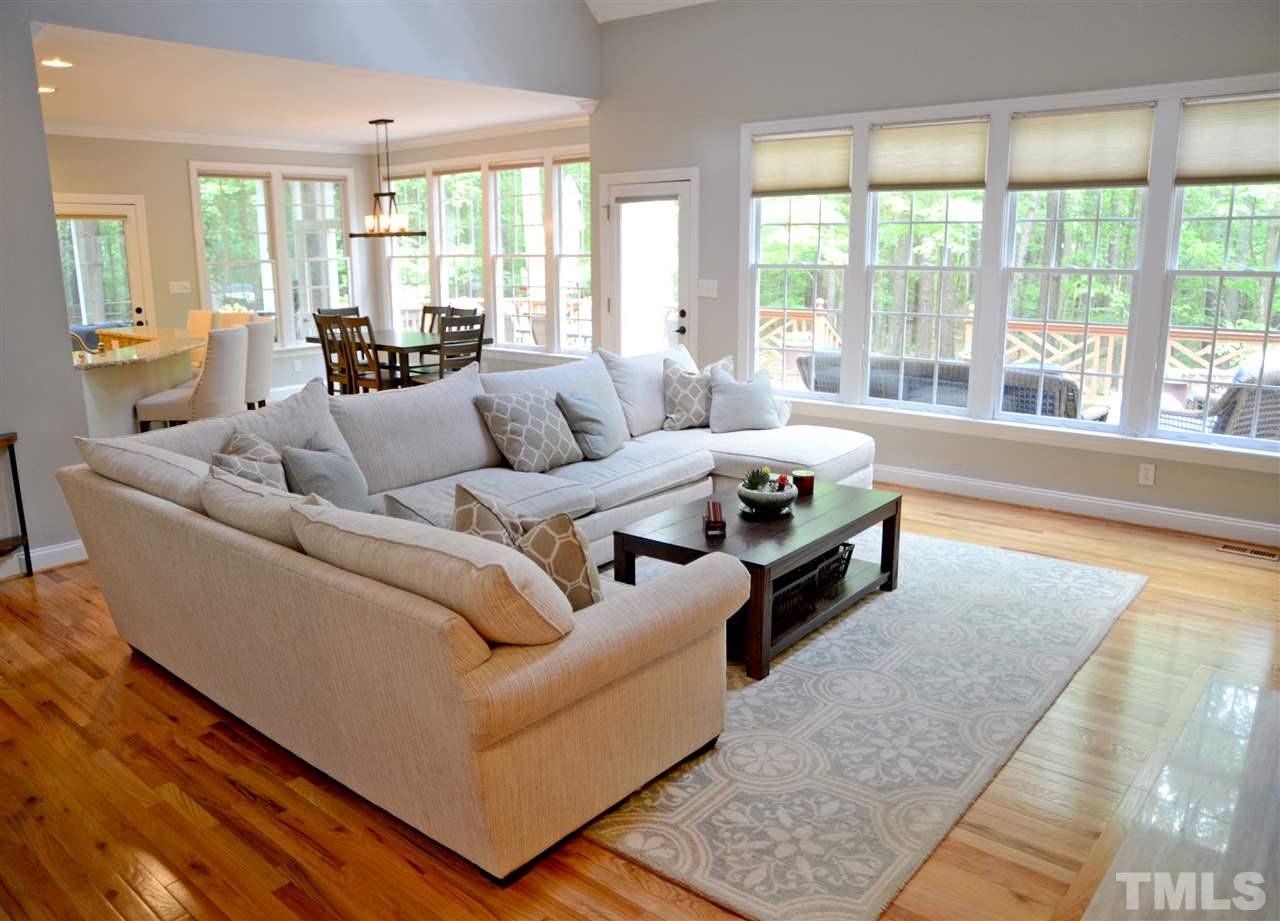 5800 Stone Canyon Court Raleigh, NC 27613 - Photo 5 of 30 WOW! What glorious light this wall of windows allows to shine in daily! Cathedral ceiling with two skylights provide the atmosphere of an airy sanctuary!