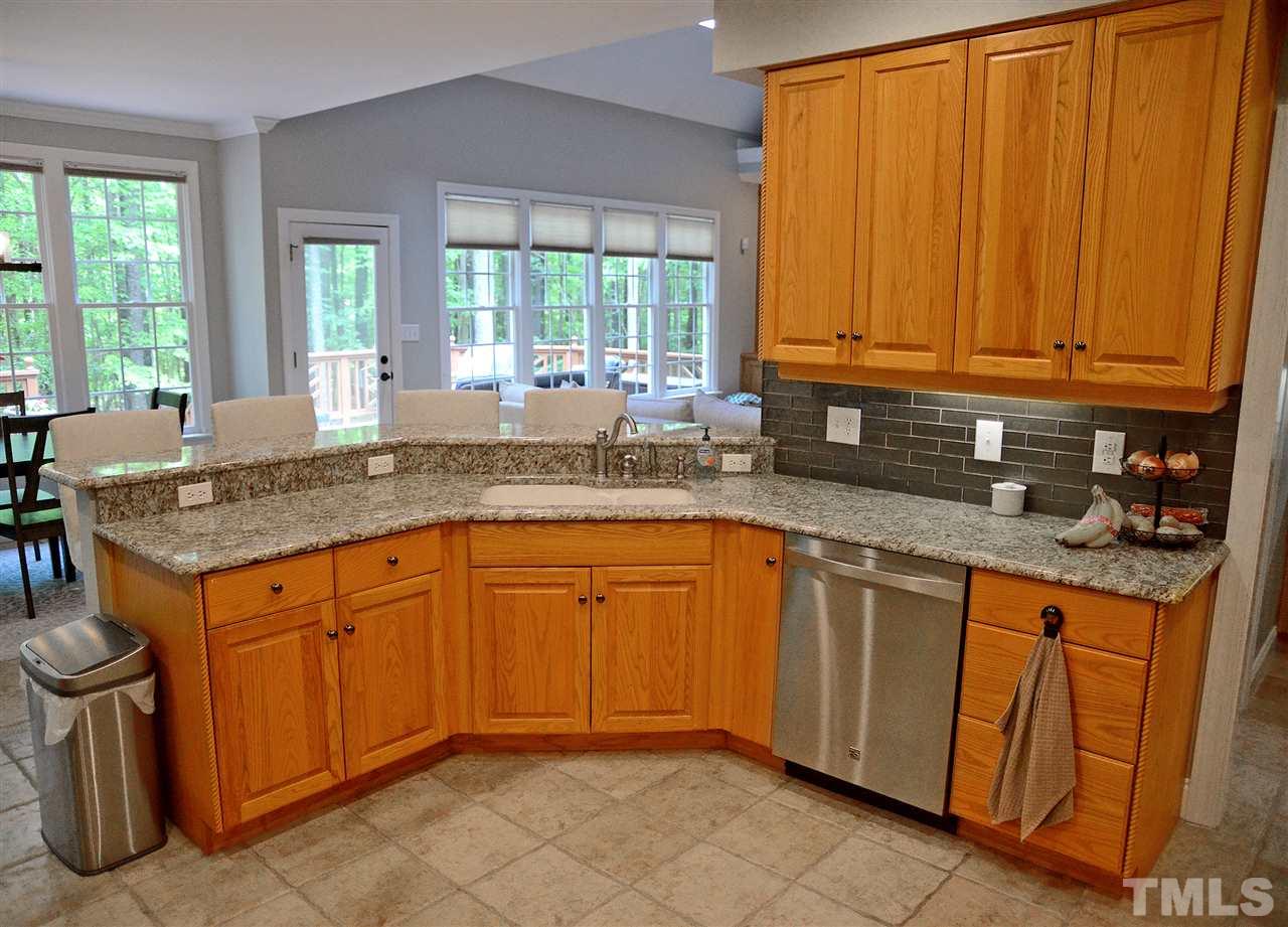 5800 Stone Canyon Court Raleigh, NC 27613 - Photo 7 of 30 If you enjoy cooking or entertaining or just having plenty of room to prepare, this kitchen is perfect! Updated with granite and subway tile back splash, stainless steel appliances, gas cook top and double oven! Beautiful tile floor for easy maintenance!