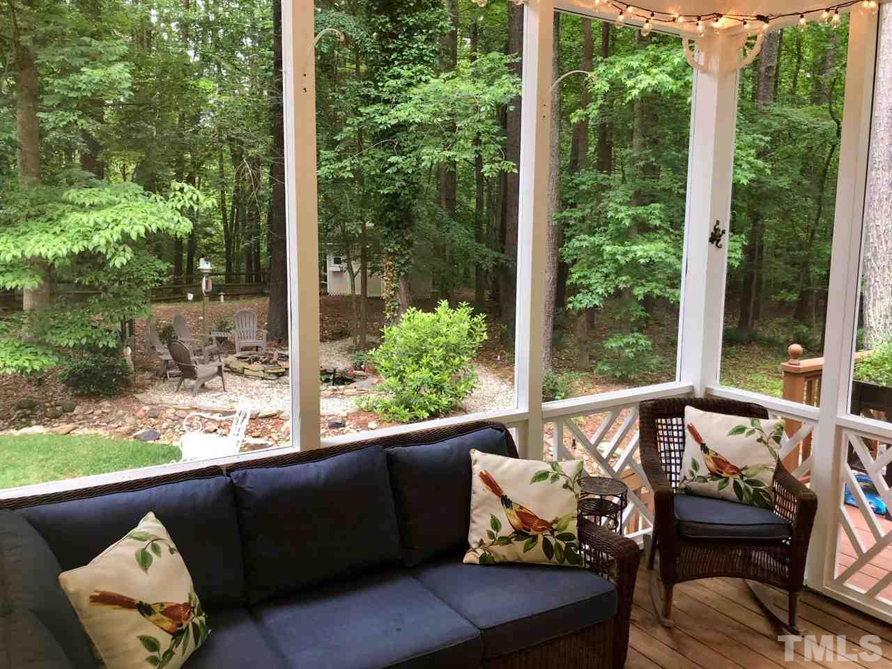 5800 Stone Canyon Court Raleigh, NC 27613 - Photo 9 of 30 Darling screened porch area peeks over the firepit and water feature. Hear the trickle of water as you picture yourself with a great book or chatting with a friend in this cozy space. Also perfect for little ones to play in a protected space.