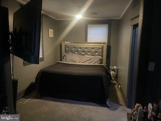 4220 Hamilton Avenue Baltimore, MD 21206 - Photo 16 of 28 a bedroom with a bed and a night stand