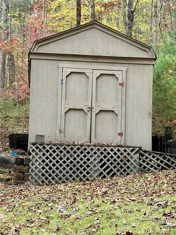 a view of a yard with wooden fence