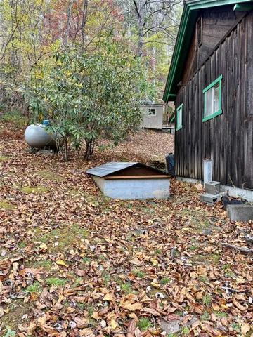 a backyard of a house with barbeque oven and outdoor seating