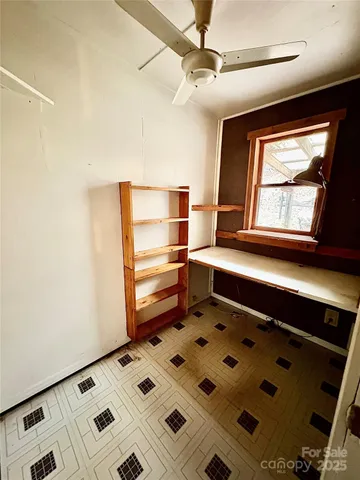 a view of a bedroom with wooden floor and a bathroom