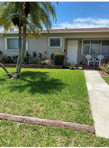 a front view of house with yard and outdoor seating