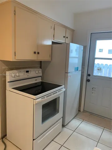 a kitchen with a stove and a refrigerator