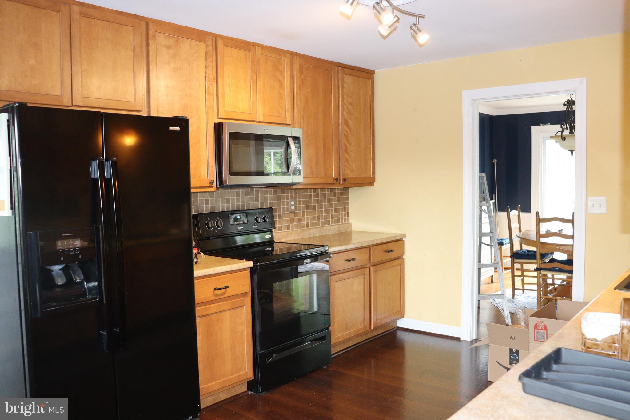 229 Dover Road Warrenton, VA 20186 - Photo 11 of 32 a kitchen with stainless steel appliances granite countertop a stove a refrigerator and a microwave