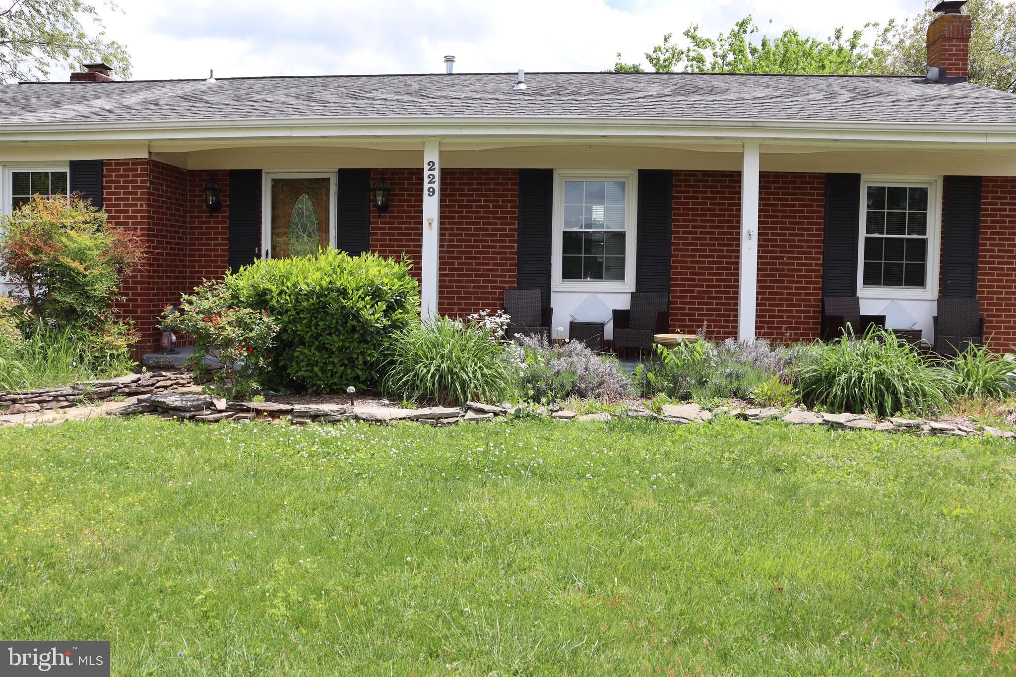 229 Dover Road Warrenton, VA 20186 - Photo 19 of 32 a view of a house with a yard and plants
