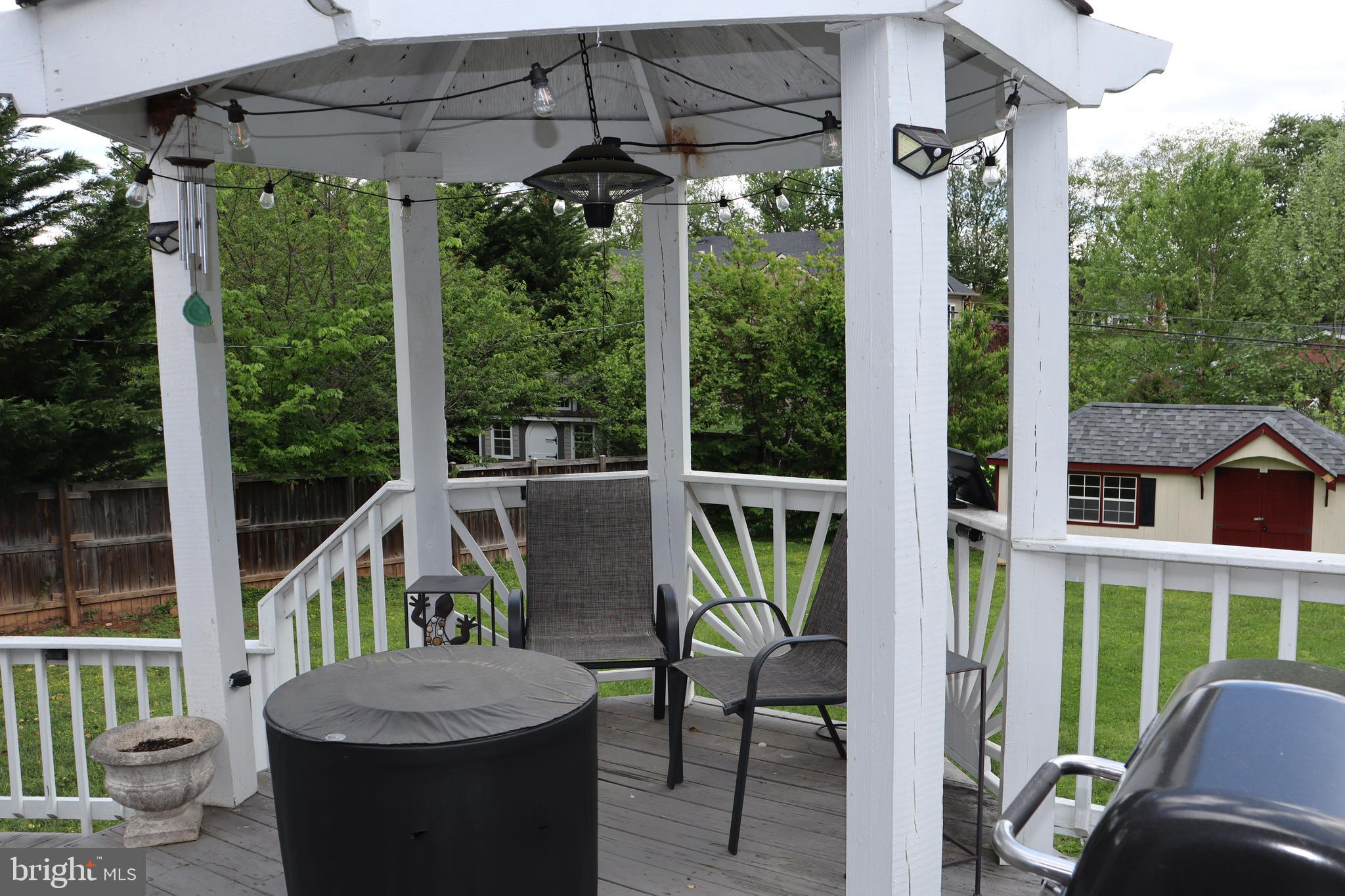 229 Dover Road Warrenton, VA 20186 - Photo 26 of 32 a view of a patio with a table chairs and a porch