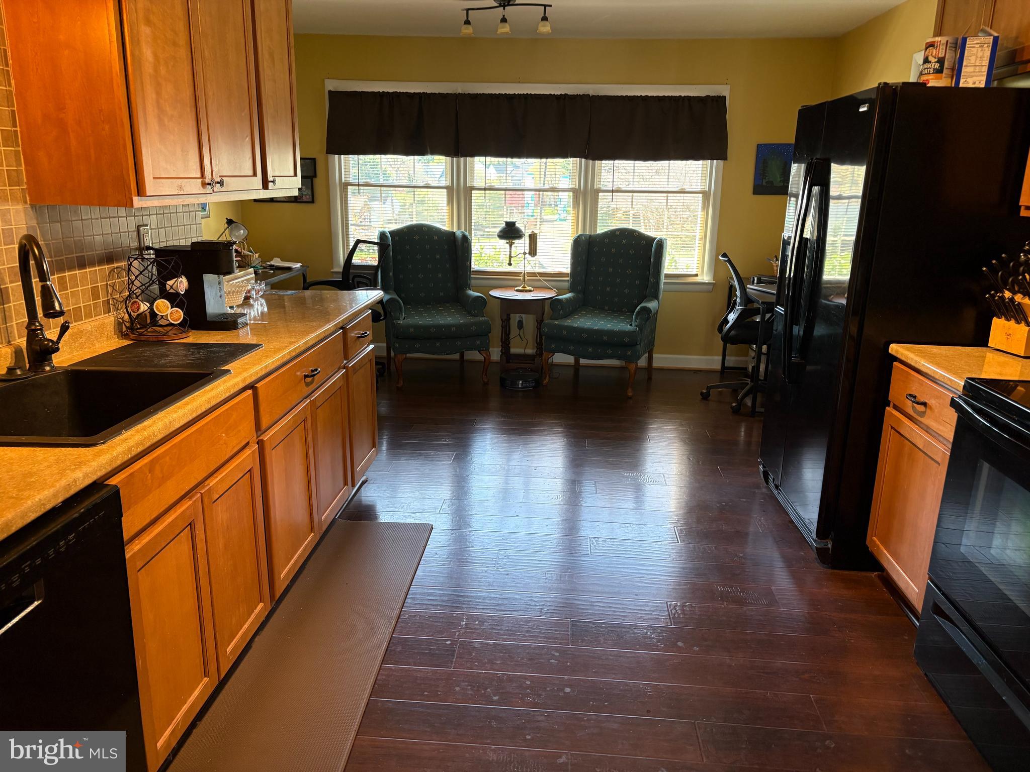 229 Dover Road Warrenton, VA 20186 - Photo 8 of 32 a open kitchen with granite countertop a stove top oven a sink dishwasher and white cabinets with wooden floor