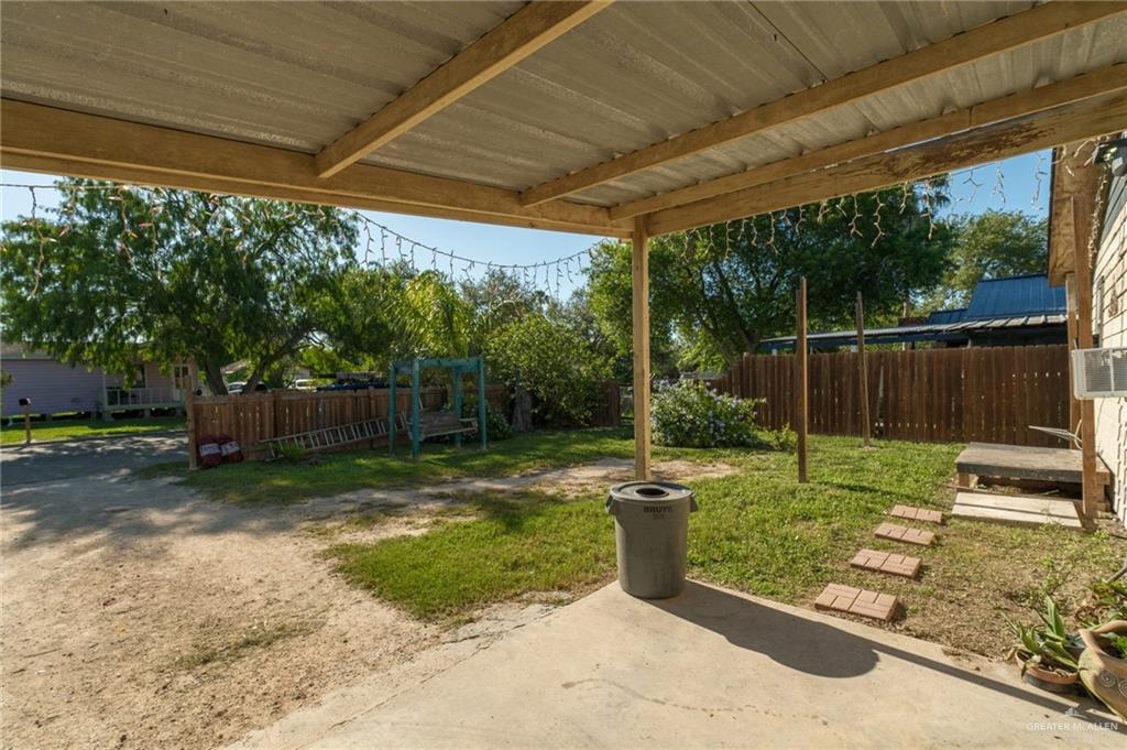 22899 Angel Street Primera, TX 78552 - Photo 12 of 19 a view of a backyard with table and chairs under an umbrella with a small yard