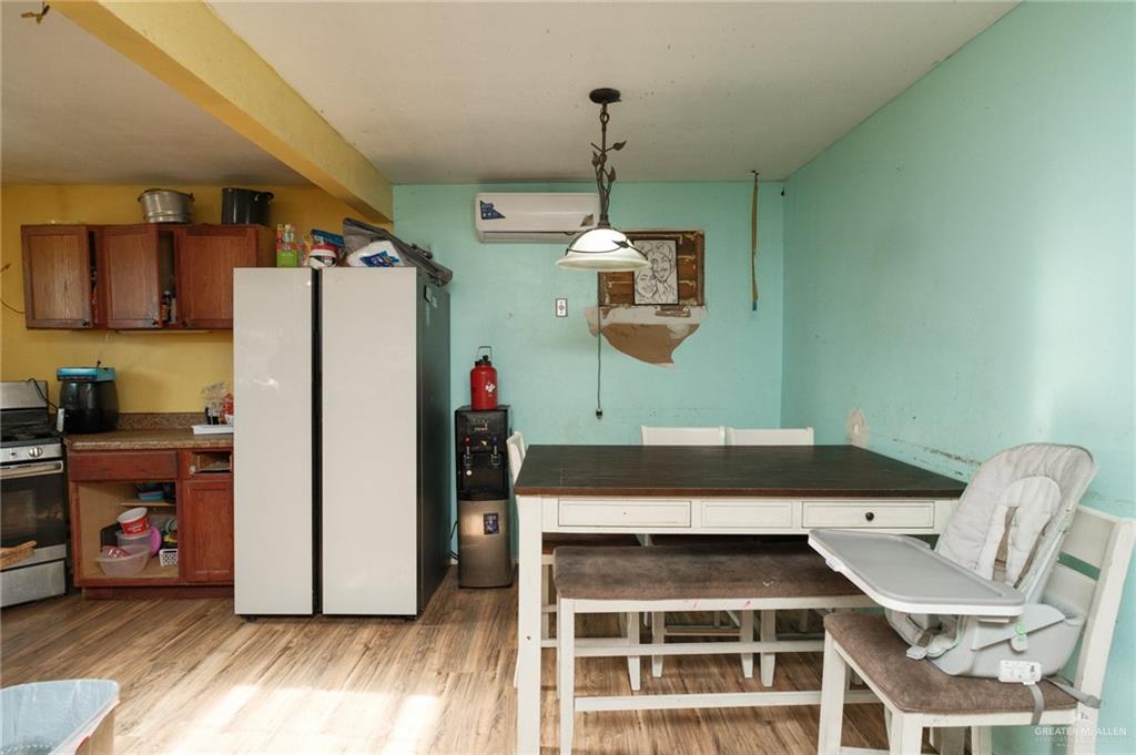 22899 Angel Street Primera, TX 78552 - Photo 2 of 19 a kitchen with a refrigerator and a wooden floor