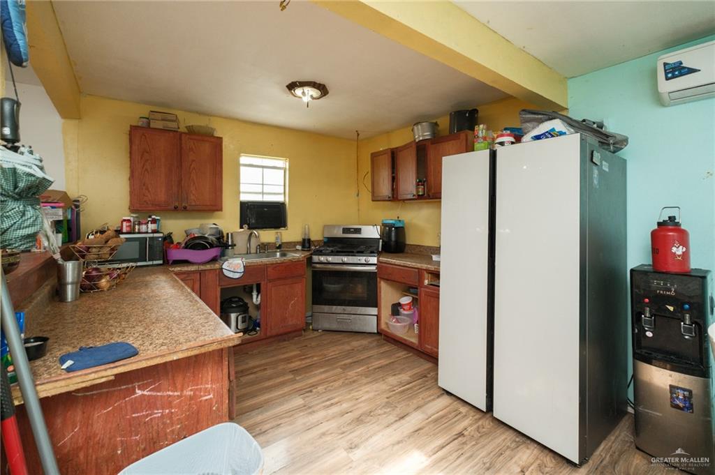 22899 Angel Street Primera, TX 78552 - Photo 3 of 19 a kitchen with a refrigerator and a counter top space