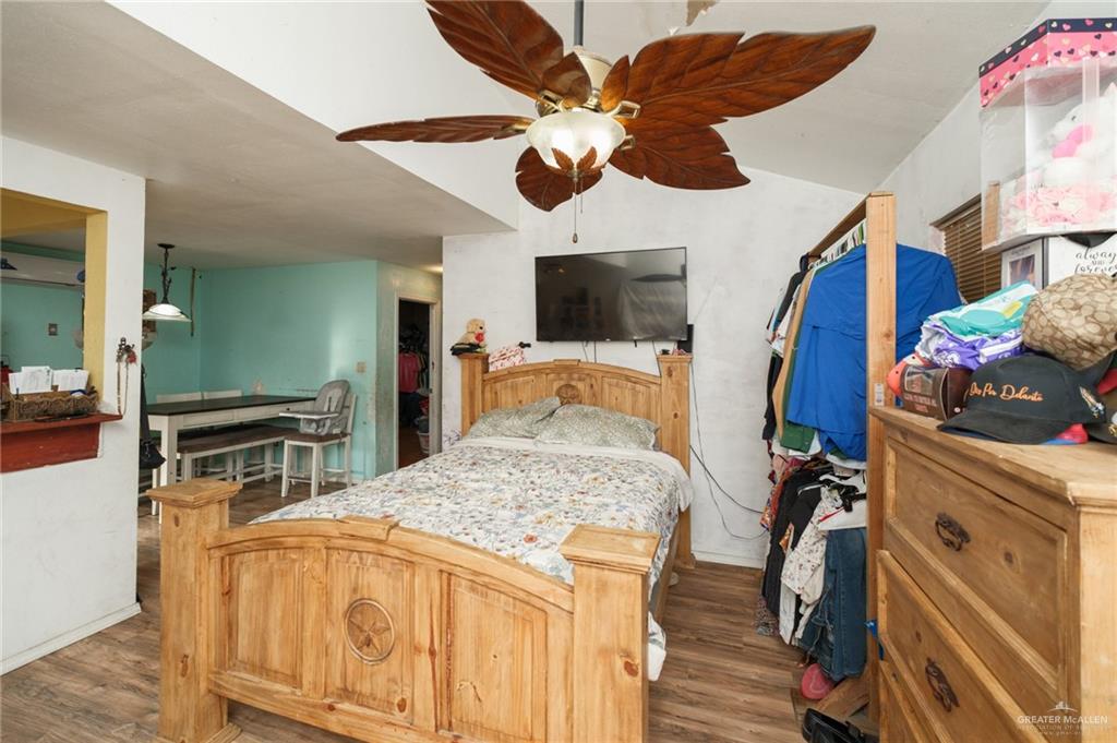 22899 Angel Street Primera, TX 78552 - Photo 7 of 19 a bedroom with a bed and wooden floor