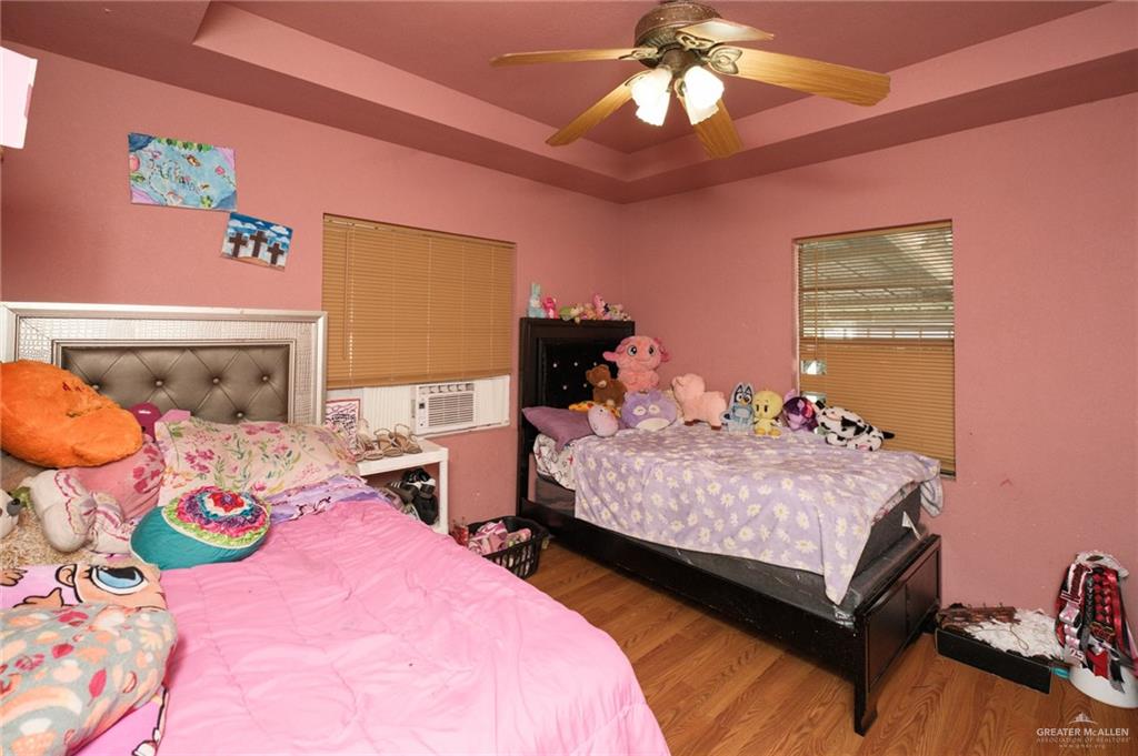 22899 Angel Street Primera, TX 78552 - Photo 9 of 19 a bedroom with a bed and a chandelier