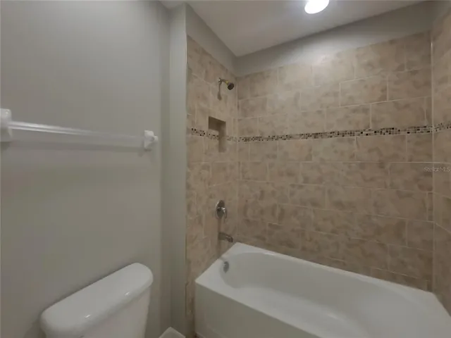 a bathroom with a shower and a toilet