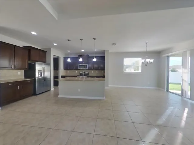 a large kitchen with stainless steel appliances cabinets a sink and a counter top space