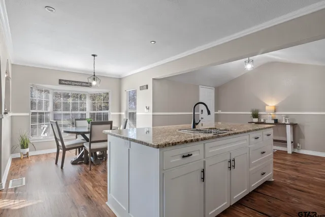 a view of kitchen island with wooden cabinets and wooden floor