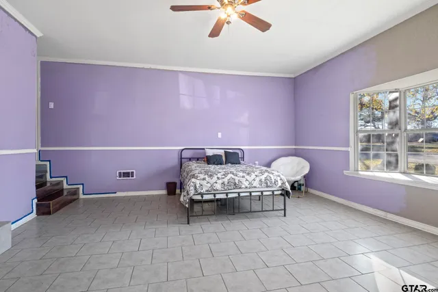 a bedroom with a bed and a window