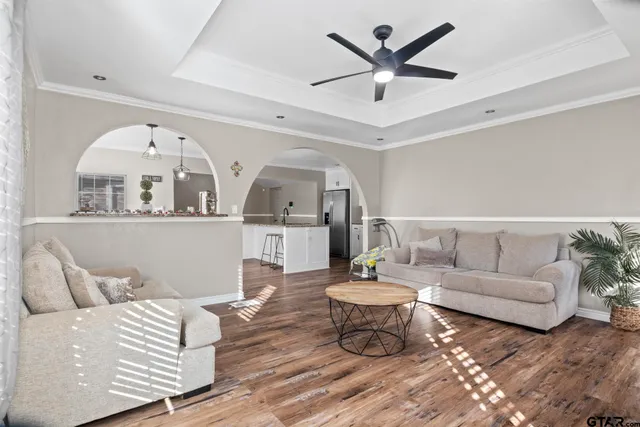 a living room with furniture and wooden floor