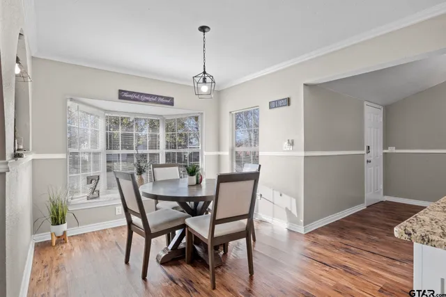 a view of a dining room with furniture window and wooden floor