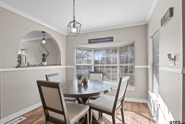 a view of a dining room with furniture window and wooden floor