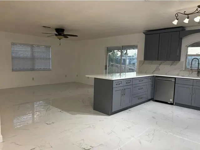 a kitchen with a sink cabinets and window