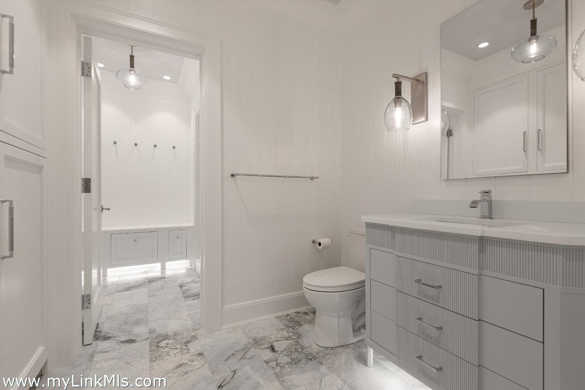 37 Sankaty Head Road Nantucket, MA 02554 - Photo 48 of 65 a bathroom with a sink toilet a mirror and shower