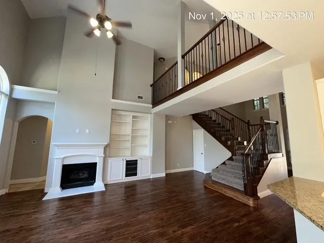 a view of entryway livingroom and hall with wooden floor