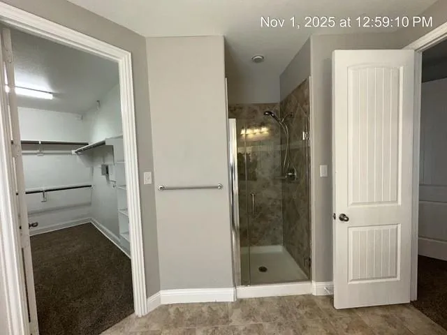 a bathroom with a glass shower door